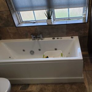 Professional bathtub installation with modern tiling by Karl Andy Plumbing.