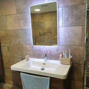 Modern bathroom sink and LED mirror installation by Karl Andy Plumbing
